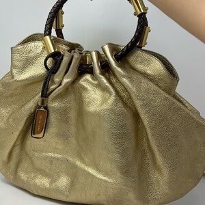 MICHAEL KORS hobo wide metal gold bag in a half circle with firm brown handle